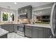 Renovated kitchen with stainless steel appliances, gray cabinetry, stylish backsplash, and an open layout concept at 5663 Brookstone Nw Dr, Acworth, GA 30101