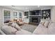 Cozy living room with a fireplace, built-in shelves, large windows, and comfortable seating, perfect for relaxing at 5663 Brookstone Nw Dr, Acworth, GA 30101