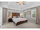 Spacious main bedroom boasts a tray ceiling, a fan, and windows with plenty of natural light at 5663 Brookstone Nw Dr, Acworth, GA 30101