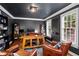 Stylish home office featuring dark walls, wooden accents, and ample natural light for a productive workspace at 5663 Brookstone Nw Dr, Acworth, GA 30101
