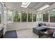 Bright sun room with large windows, skylights, tile flooring, and comfortable wicker furniture at 5663 Brookstone Nw Dr, Acworth, GA 30101