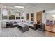 Bright sun room with large windows, skylights, tile flooring, and comfortable wicker furniture at 5663 Brookstone Nw Dr, Acworth, GA 30101