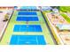 Aerial view of the community's pristine blue tennis courts, a playground and a swimming pool facility at 5663 Brookstone Nw Dr, Acworth, GA 30101