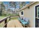 Home's outdoor porch area features blue chairs and a wooden deck, surrounded by nature at 150 Burke St Ne, Marietta, GA 30060