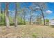 Large, grassy backyard with scattered trees offering shade and privacy at 150 Burke St Ne, Marietta, GA 30060
