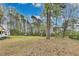 Expansive backyard with mature trees offering privacy, adjacent to the main house and camper at 150 Burke St Ne, Marietta, GA 30060