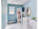 Bright bathroom featuring a shower, single sink vanity, and neutral wall paint at 150 Burke St Ne, Marietta, GA 30060