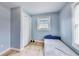 Bedroom featuring pale blue walls, a large window, and closet storage space at 150 Burke St Ne, Marietta, GA 30060