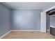 This bedroom offers soothing blue walls, modern baseboards, light wood floors, and closet storage space at 150 Burke St Ne, Marietta, GA 30060