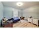 Cozy bedroom with neutral blue walls, light wood flooring, and vintage storage cabinets at 150 Burke St Ne, Marietta, GA 30060