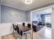 Dining room with a wood table and views to a living area featuring potted plants, a couch, and an office space at 150 Burke St Ne, Marietta, GA 30060