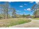 Expansive front yard with mature trees and a long driveway leading to a charming home at 150 Burke St Ne, Marietta, GA 30060
