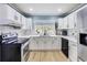 Modern kitchen with stainless steel appliances, light cabinets, and wood floors at 150 Burke St Ne, Marietta, GA 30060
