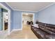 Light-filled living room with hardwood floors, a leather couch, and open access to a dining area at 150 Burke St Ne, Marietta, GA 30060