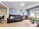 Cozy living room with natural light, featuring a leather couch, desk, and decorous potted plants at 150 Burke St Ne, Marietta, GA 30060