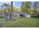 Home features a large fenced yard with a shed and mature trees at 196 Wadley Nw St, Atlanta, GA 30314