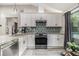 Bright kitchen showcasing white cabinets, stainless steel appliances, and stylish backsplash at 196 Wadley Nw St, Atlanta, GA 30314