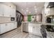 Open kitchen with granite countertops, stainless appliances, and view to the living area at 196 Wadley Nw St, Atlanta, GA 30314