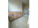 Bright bathroom featuring a light wood vanity, undermount sink, and a frameless glass shower with stone-look tile at 1968 8Th St, Chamblee, GA 30341