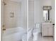Bright bathroom featuring tub, tile accents, shower head and neutral color palette at 1968 8Th St, Chamblee, GA 30341