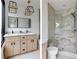 Bathroom featuring a double vanity, modern fixtures, granite counters, and glass shower at 1968 8Th St, Chamblee, GA 30341