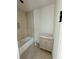 Cozy bathroom featuring a tub with neutral tile surround and a vanity with shaker-style cabinets at 1968 8Th St, Chamblee, GA 30341