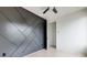 Bedroom featuring a geometric accent wall, ceiling fan, and light hardwood floors at 1968 8Th St, Chamblee, GA 30341
