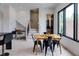 Dining area adjacent to a staircase and a work area, featuring modern decor and ample natural light at 1968 8Th St, Chamblee, GA 30341