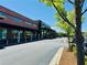 Exterior of a commercial building featuring brick, large windows, and landscaping under a clear, blue sky at 1968 8Th St, Chamblee, GA 30341