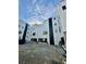 Modern condo building with white siding, black accents, garages and a gravel parking area at 1968 8Th St, Chamblee, GA 30341