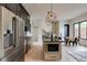 Modern kitchen with stainless steel appliances, kitchen island, and striking geometric light fixtures at 1968 8Th St, Chamblee, GA 30341