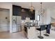 Modern kitchen features a black marble island, stainless steel appliances, and unique geometric pendant lighting at 1968 8Th St, Chamblee, GA 30341