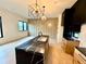 Bright kitchen featuring a black marble island with a sink, custom cabinets, and modern lighting fixtures at 1968 8Th St, Chamblee, GA 30341