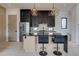 Modern kitchen features a black marble island, stainless steel appliances, and unique geometric pendant lighting at 1968 8Th St, Chamblee, GA 30341