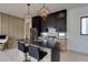 Modern kitchen features a black marble island, stainless steel appliances, and unique geometric pendant lighting at 1968 8Th St, Chamblee, GA 30341
