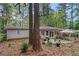 Secluded backyard featuring a stone patio with seating and lush greenery at 1998 Jordan Terrace Ne, Atlanta, GA 30345