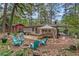 Backyard stone patio with outdoor seating, mature trees, and green plants at 1998 Jordan Terrace Ne, Atlanta, GA 30345