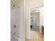 This bathroom offers a shower-tub combination and easy access to an adjacent room at 3597 Old Maple Rd, Johns Creek, GA 30022