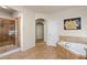 Well-lit bathroom featuring a walk-in shower with a seat and a separate bathtub at 3597 Old Maple Rd, Johns Creek, GA 30022