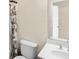 This bathroom is quaint, and features a sink-vanity combination and a toilet at 3597 Old Maple Rd, Johns Creek, GA 30022