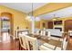 Eat-in kitchen area adjacent to the living room featuring an elegant light fixture at 3597 Old Maple Rd, Johns Creek, GA 30022