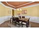 Formal dining room with elegant chandelier, wainscoting and hardwood floors at 3597 Old Maple Rd, Johns Creek, GA 30022