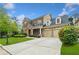 Charming two-story brick home featuring a well-manicured lawn, driveway and attached two car garage at 3597 Old Maple Rd, Johns Creek, GA 30022