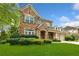 Charming two-story brick home featuring a well-manicured lawn and attached two car garage at 3597 Old Maple Rd, Johns Creek, GA 30022