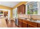 View of the kitchen with stainless steel appliances and granite countertops with hardwood floors at 3597 Old Maple Rd, Johns Creek, GA 30022