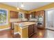 Well-lit kitchen features stainless appliances, a center island, and ample cabinet space at 3597 Old Maple Rd, Johns Creek, GA 30022