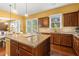 Kitchen with island and an open floorplan with a view to the dining area at 3597 Old Maple Rd, Johns Creek, GA 30022