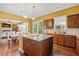 Open kitchen with island, adjacent dining area, and hardwood floors, great for entertaining at 3597 Old Maple Rd, Johns Creek, GA 30022