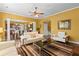 Open-concept living room with hardwood floors and a view of the adjacent dining room and kitchen at 3597 Old Maple Rd, Johns Creek, GA 30022