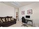 Home office with a comfortable sofa, desk, and chair, perfect for a productive workspace at 3597 Old Maple Rd, Johns Creek, GA 30022